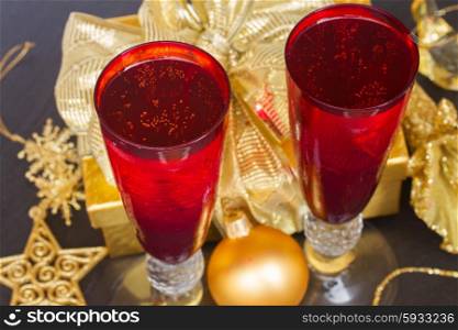 christmas champagne. christmas champagne in red glasses with golden decorations
