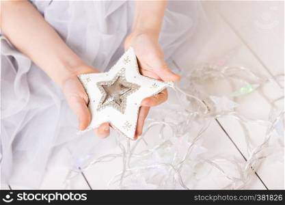 Christmas - children's hands girl holding a star