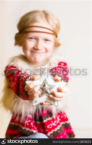 Christmas - children's hands girl holding a star and smiling