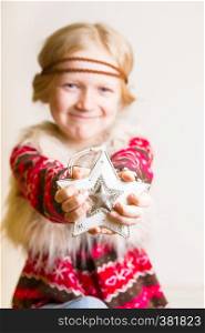 Christmas - children's hands girl holding a star and smiling