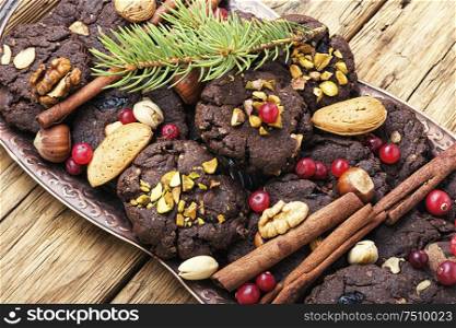 Christmas chocolate cookies with nuts, hazelnuts and pistachios.Christmas food. Plate with tasty Christmas cookies