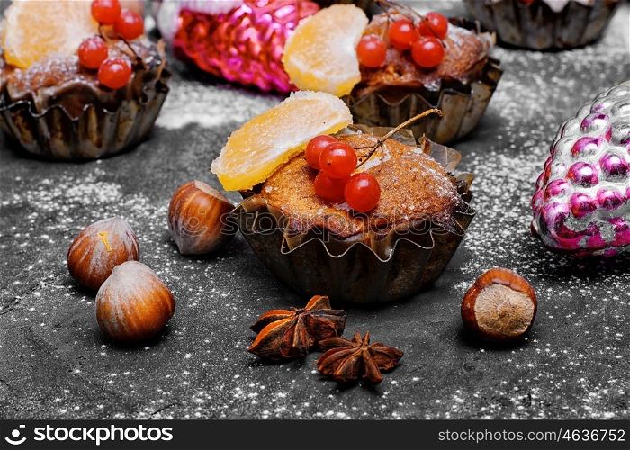 Christmas chocolate cupcake. few Christmas cupcakes with fruits on black background