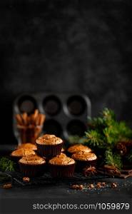 Christmas cinnamon muffins on black background