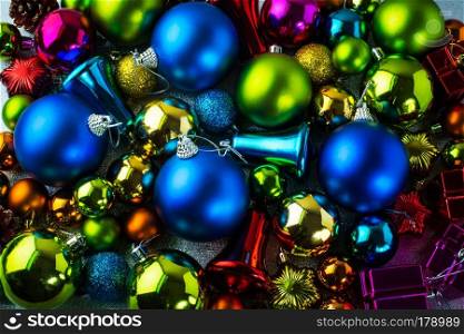 Christmas colorful decoration of blue, red, purple, yellow, gold, green balls, jingle bells background
