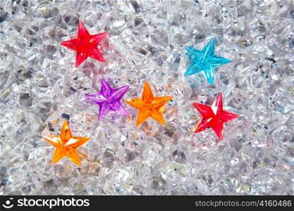 christmas colorful glass stars on cold ice background