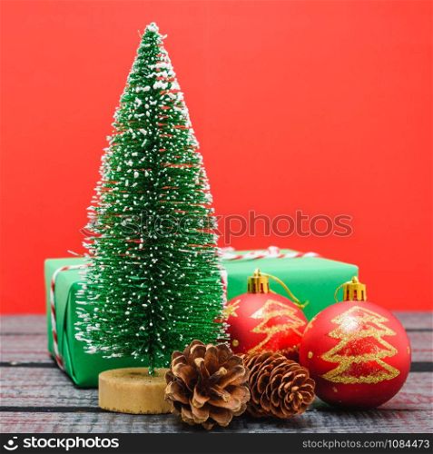 Christmas composition and decorations, minimal green fir tree branches with snow on red background. Merry Christmas concept. Copy space for text