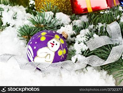 Christmas composition, decoration, gold Christmas ball in winter snow with