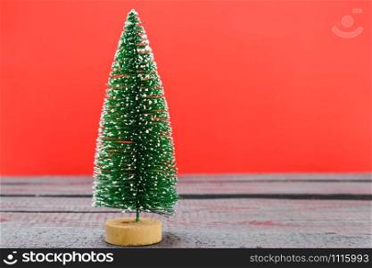 Christmas composition decorations, minimal green fir tree branches with snow on red background. Merry Christmas concept. Copy space for text
