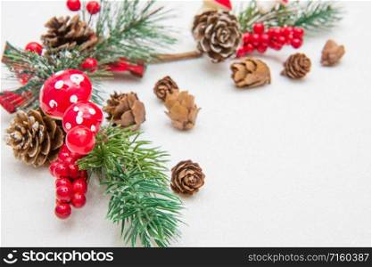 Christmas composition. Fir tree branches, red decorations on white background.