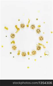 Christmas composition. New Year or Christmas pattern flat lay top view Xmas holiday celebration decorative golden round wreath frame on white background with copy space. Template of greeting card