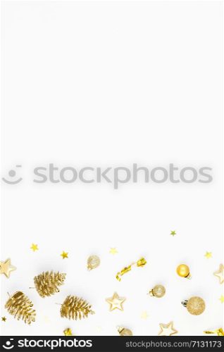 Christmas composition. New Year or Christmas pattern flat lay top view Xmas holiday celebration decorative golden toys and cones frame on white background with copy space. Template of greeting card