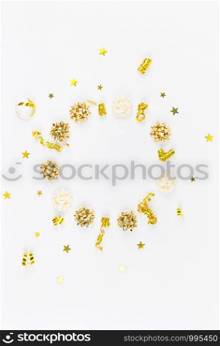 Christmas composition. New Year or Christmas pattern flat lay top view Xmas holiday celebration decorative golden round wreath frame on white background with copy space. Template of greeting card