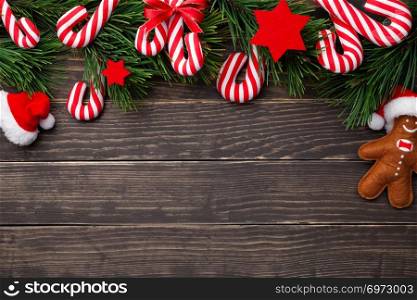 Christmas composition with candy canes on wooden background. Copy space. Top view 