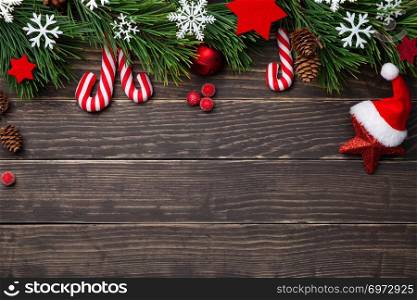 Christmas composition with decorations on wooden background. Copy space. Top view 