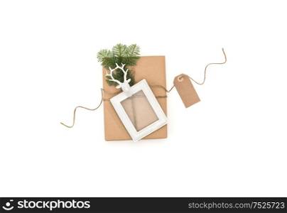 Christmas composition with gift and picture frame on white background. Flat lay