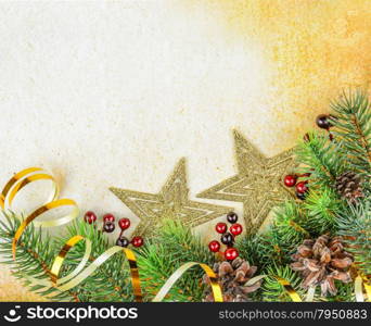 Christmas compositionon with fir branches and golden stars on a background of old paper
