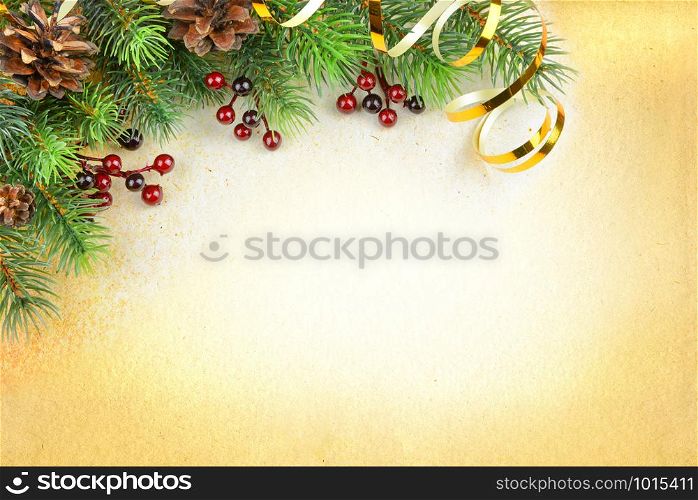 Christmas compositionon with green spruce branches, cones, red holly berries and golden serpentine on a background of old paper