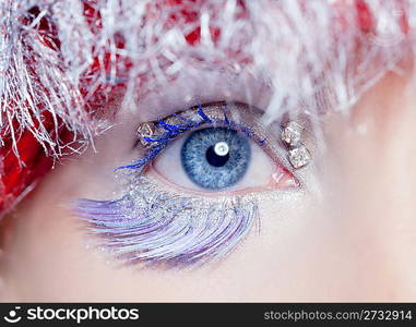 christmas concept blue eye makeup winter red silver macro closeup