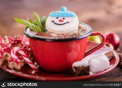 christmas concept snowman cookie in hot cocoa chocolate red mug