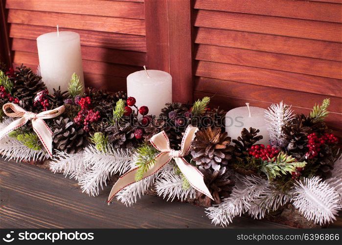 Christmas cones candlestick. Christmas candlestick on the window, decoration with cones