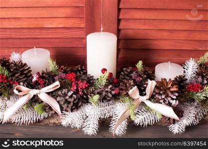 Christmas cones candlestick. Christmas candlestick on the window, decoration with cones