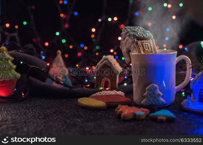 Christmas cookies and cup of tea. Christmas cookies and cup of tea on dark color bokeh lights background