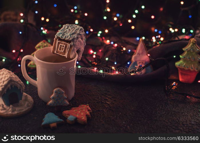 Christmas cookies and cup of tea. Christmas cookies and cup of tea on dark color bokeh lights background