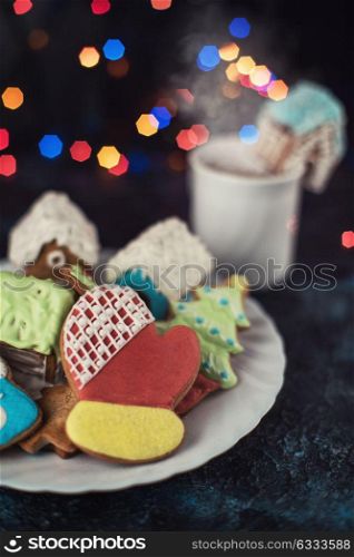 Christmas cookies and cup of tea. Christmas cookies and cup of tea on dark color bokeh lights background