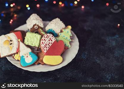 Christmas cookies and cup of tea. Christmas cookies on dark background with bokeh lights