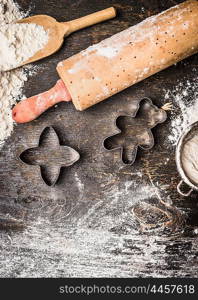 Christmas cookies baking. Preparation with bake molds, rolling pin and flour on wooden background, top view