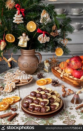 Christmas cookies filled with marmalade and dipped in chocolate, arranged on a plate