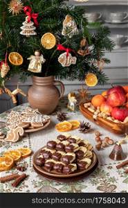 Christmas cookies filled with marmalade and dipped in chocolate, arranged on a plate