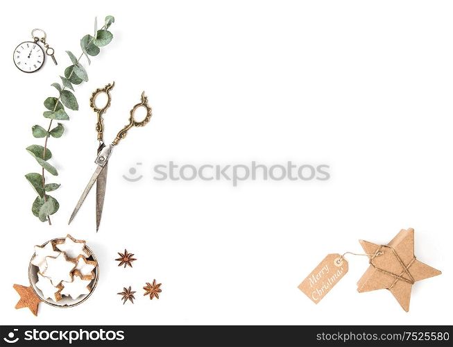 Christmas cookies, gift box and eucalyptus plant on white background. Flat lay