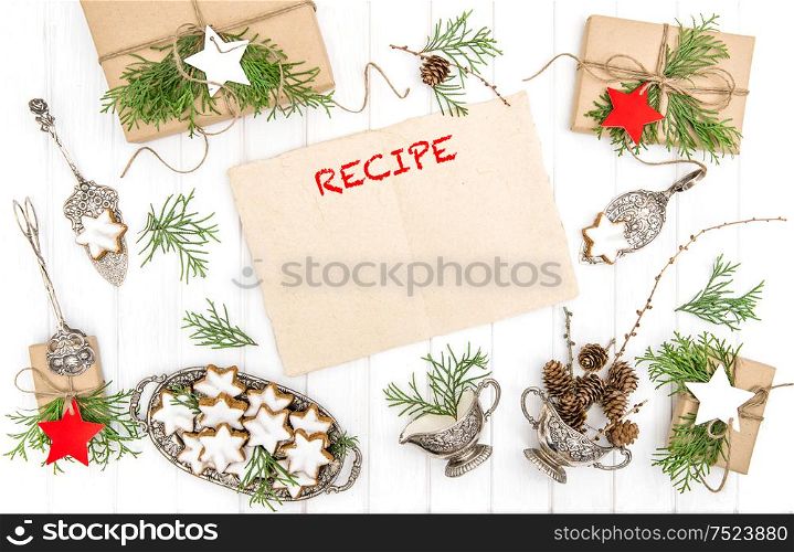 Christmas cookies, gifts and paper sheet for recipe. Festive decoration. Vintage cutlery. Flat lay