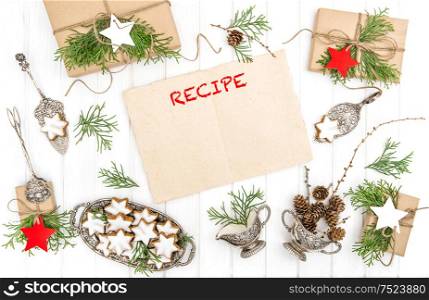 Christmas cookies, gifts and paper sheet for recipe. Festive decoration. Vintage cutlery. Flat lay