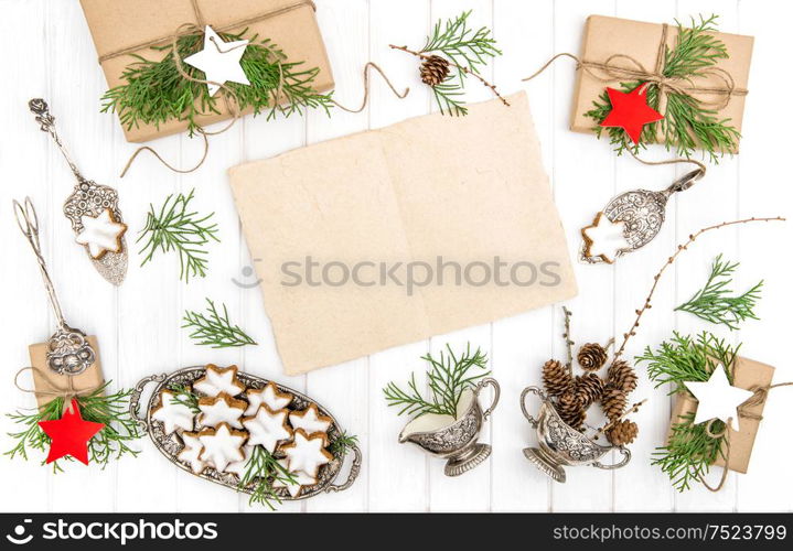 Christmas cookies, gifts and paper sheet for your text. Festive decoration. Vintage cutlery. Flat lay