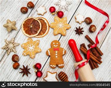 Christmas cookies, rolling pin and baubles on a wooden background