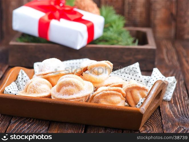 christmas cookies with creame on the wooden tray