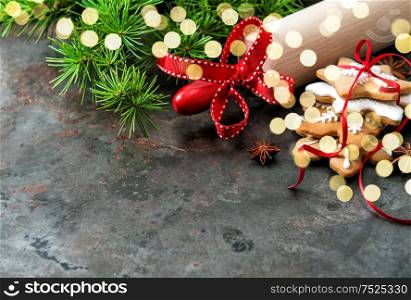 Christmas cookies with evergreen tree branches decoration. Holidays background with festive lights