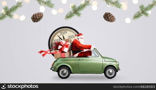 Christmas countdown arriving. Santa Claus on car delivering New Year gifts and clock at gray background. Santa Claus countdown on car