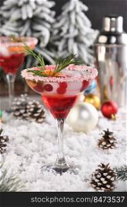 Christmas Cranberry margarita cocktail is mandarin and rosemary combined with cranberries and tequila. This cocktail is bursting with vibrant citrus and herb aromas, showcasing the best winter season fruits.Festive Christmas or New Year drink