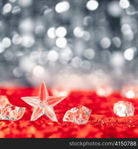 Christmas crystal star on ice cubes with blue lights bokeh background