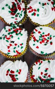 Christmas cupcakes on wooden background