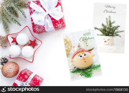 Christmas decor, Christmas balls, branches, boxes with gifts and Christmas cards on a white table.
