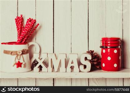 Christmas decor on the shelf - wooden letters XMAS in the kitchen. Christmas decor on the shelf