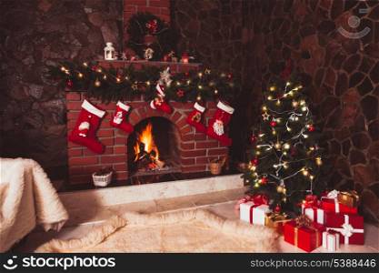 Christmas decorated fireplace and tree in the room