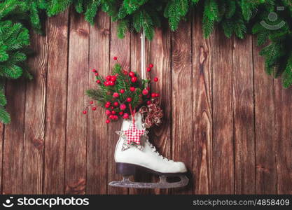 Christmas decorated skate on the wooden wall. Christmas decorated skate