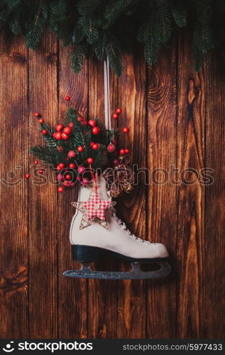 Christmas decorated skate on the wooden wall. Christmas decorated skate