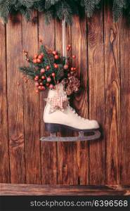Christmas decorated skate on the wooden wall. Christmas decorated skate