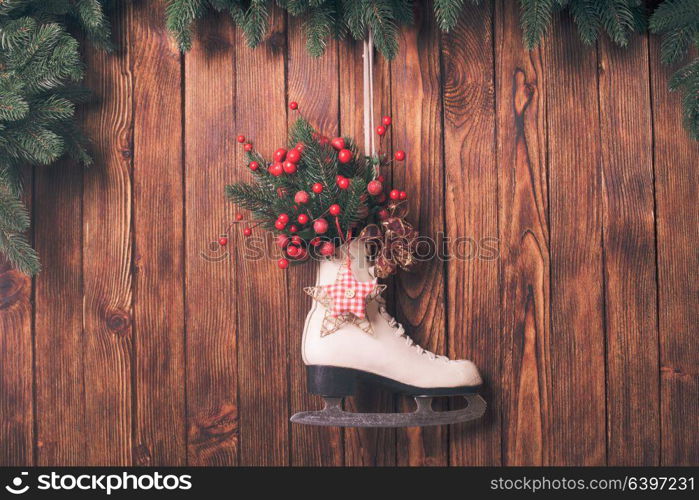 Christmas decorated skate on the wooden wall. Christmas decorated skate